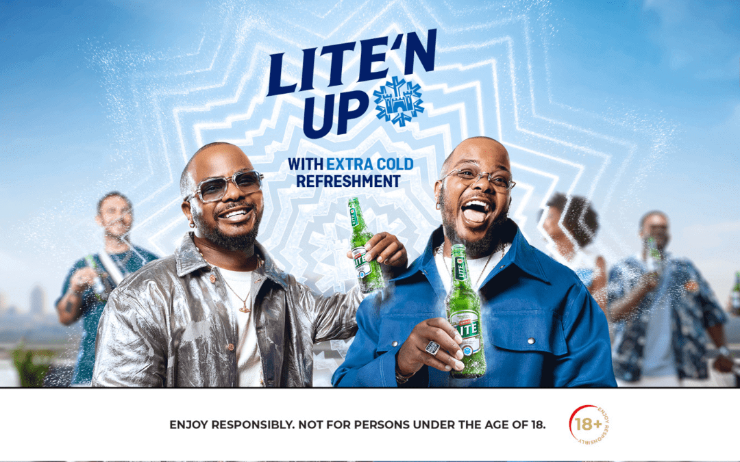 Two men smile and hold Lite beer bottles amid a bright, outdoor setting. They wear sunglasses and stylish jackets. “LITE’N UP with extra cold refreshment” appears above them. The bottom text reads, “Enjoy responsibly. Not for persons under the age of 18.”.