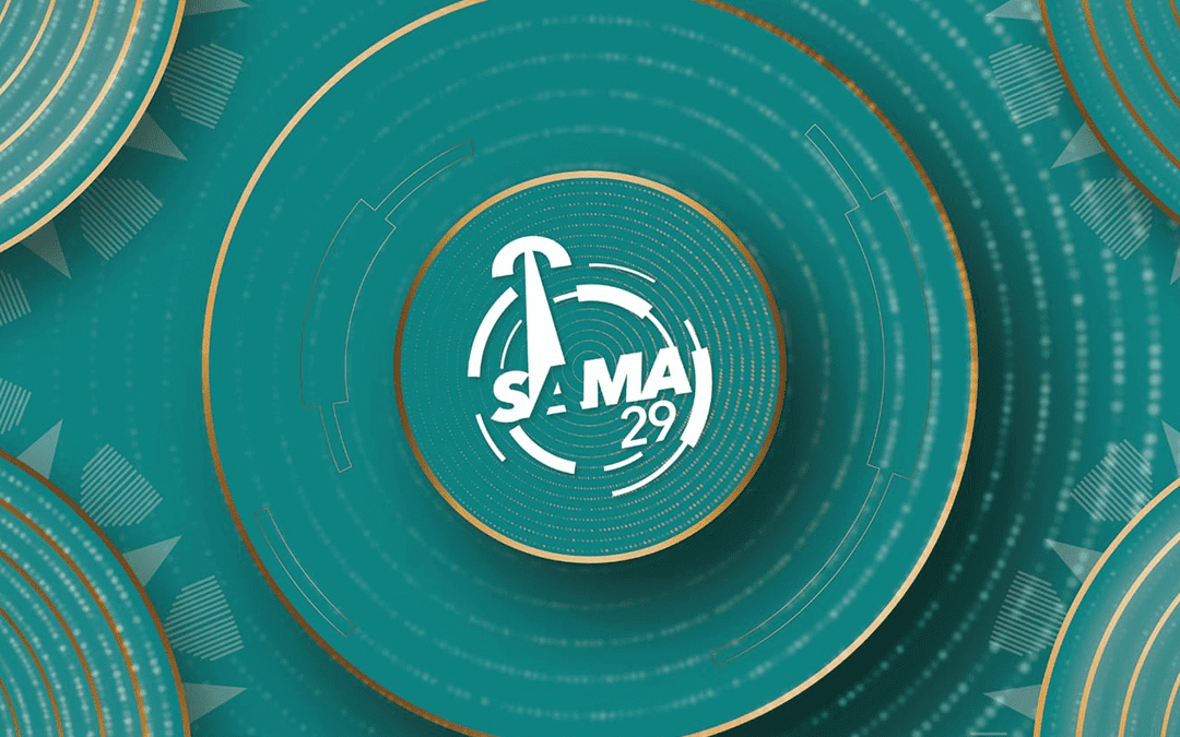 A teal circular graphic with concentric rings and gold accents features the text “SAMA 29” in white. Above the text is a stylised microphone. The background has repeated circular patterns that enhance the audio or awards theme.