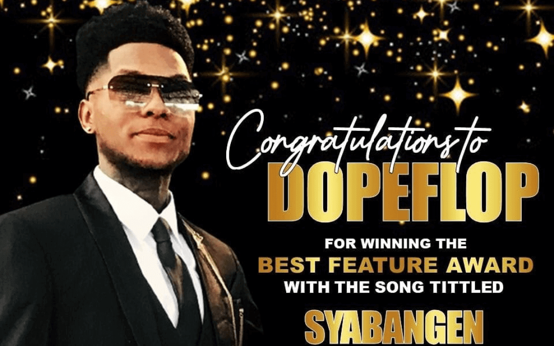 A man in a tuxedo and sunglasses stands against a background of sparkling gold stars. Text reads, “Congratulations to DOPEFLOP for winning the Best Feature Award with the song titled SYABANGEN.” The atmosphere is formal and celebratory.