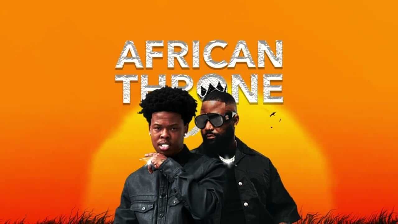 Two men in dark jackets stand in front of a large setting sun on an orange background. The words 
