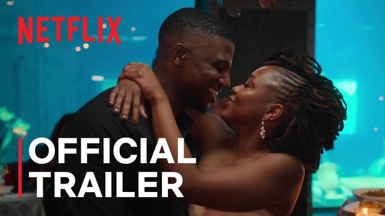 A smiling couple cuddle closely at a dinner table, gazing into each other's eyes. The Netflix logo and the words 
